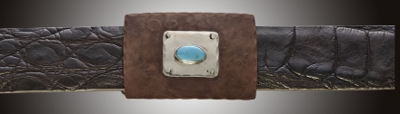 One inch rectangular buckle with pounded copper, silver inset and turquoise stone.