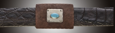 One inch rectangular buckle with pounded copper, silver inset and turquoise stone.
